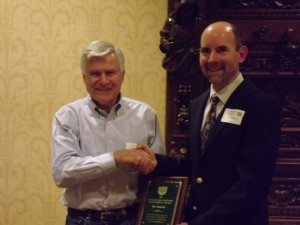 1964 Olympian Vic Zwolak accepts award from Club President Ray Christensen in 2012